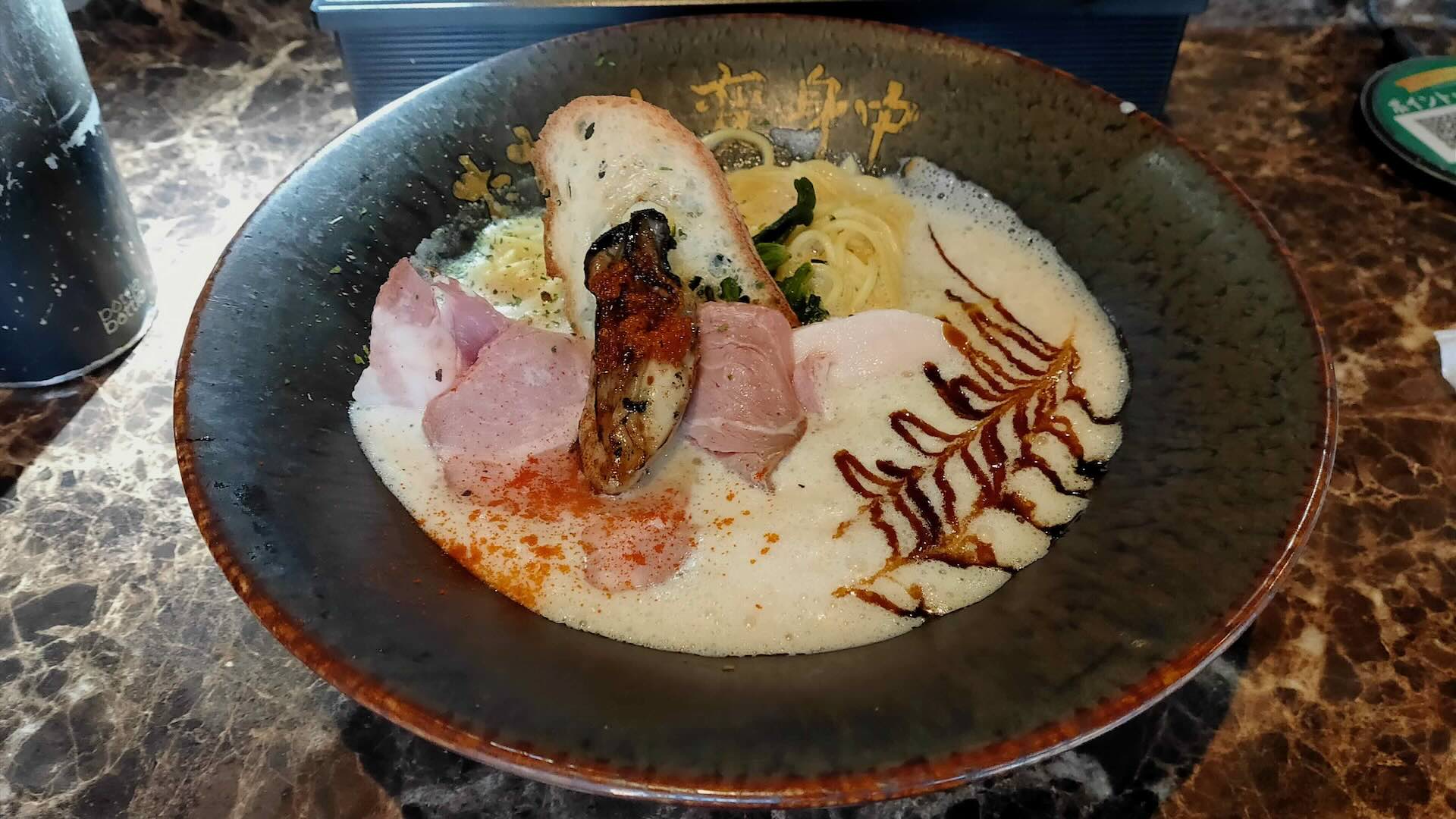 oyster ramen Nakano Tokyo at Tadaima Henshinchu — the original 牡蠣ラーメン, creamy ivory broth with oyster, sea bream and soy, topped with a whole grilled oyster and rare chashu